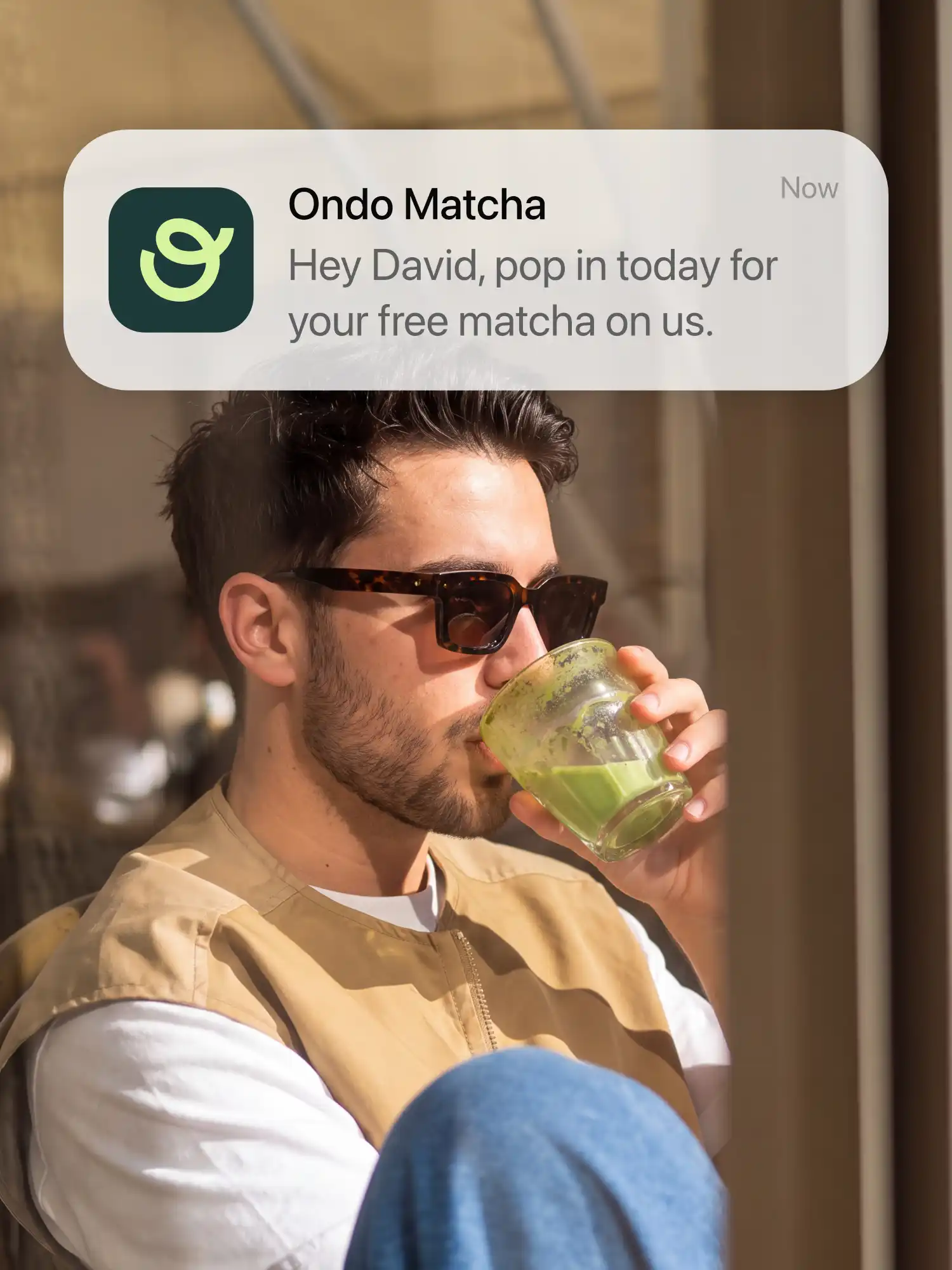 A customer drinking a matcha, with an Ondo Matcha lock-screen message: Hey David, pop in today for your free matcha on us
